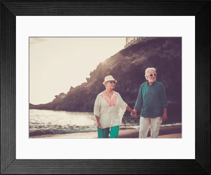 Framed Print : happy senior adult couple in love waing and smiling enjoying the summer time on the beach Framed Print : happy senior adult couple in love waing and smiling enjoying the summer time on the beach