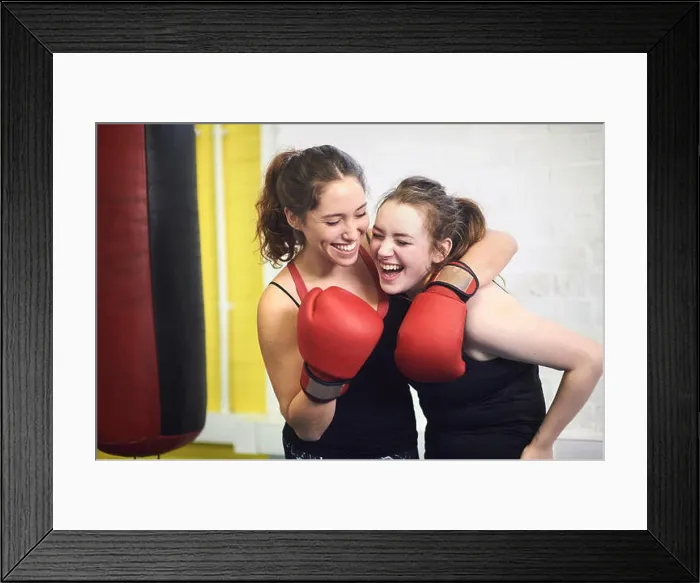 Framed Print : Two female boxing friends pretending to punch in gym Framed Print : Two female boxing friends pretending to punch in gym