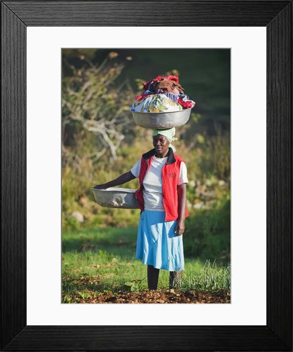Framed Print : A woman carrying washing on her head Framed Print : A woman carrying washing on her head