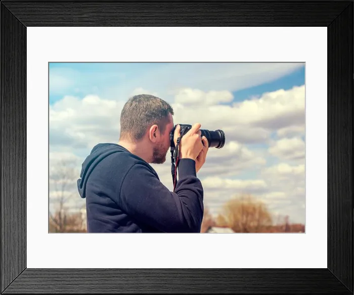 Framed Print : Person taking picture by reflex camera. Man with black photo camera in warm summer day Framed Print : Person taking picture by reflex camera. Man with black photo camera in warm summer day