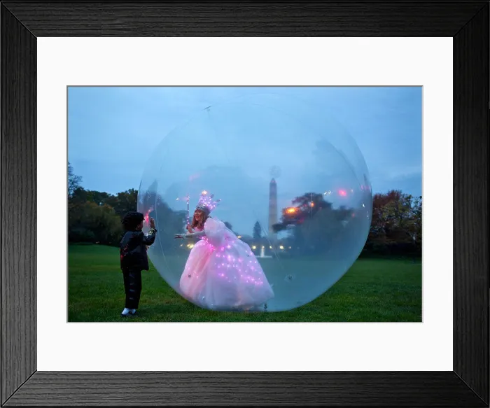 Framed Print : Glinda the Good Witch greets children from inside her bubble during Halloween on the South Lawn of the White House Framed Print : Glinda the Good Witch greets children from inside her bubble during Halloween on the South Lawn of the White House