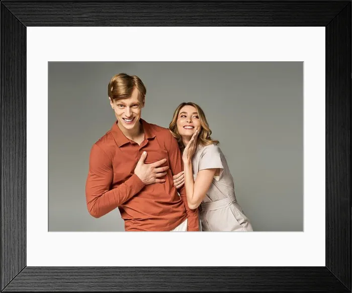 Framed Print : A stylish couple playfully interacts in spring clothing, showcasing fun fashion trends indoors Framed Print : A stylish couple playfully interacts in spring clothing, showcasing fun fashion trends indoors