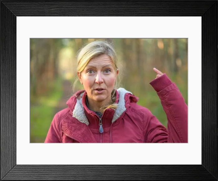 Framed Print : Blond woman in red jacket showing up her long sleeve hiding the hand almost entirely Framed Print : Blond woman in red jacket showing up her long sleeve hiding the hand almost entirely