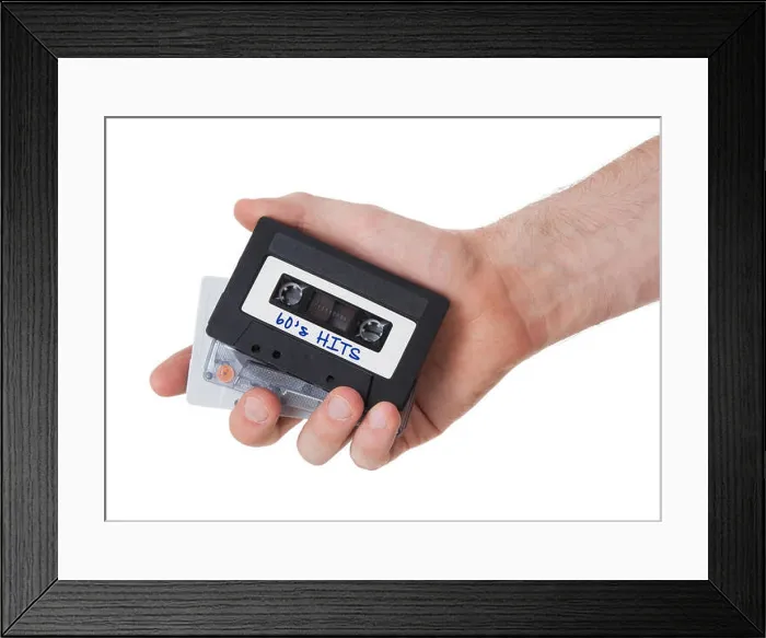 Framed Print : Vintage audio cassette tape, isolated on white background, 60's hits