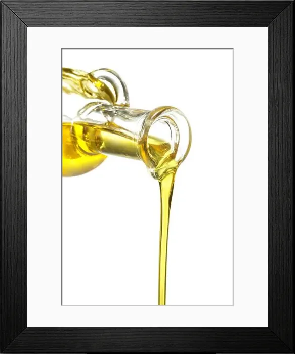 Framed Print : glass bottle pouring oil isolated on white Framed Print : glass bottle pouring oil isolated on white