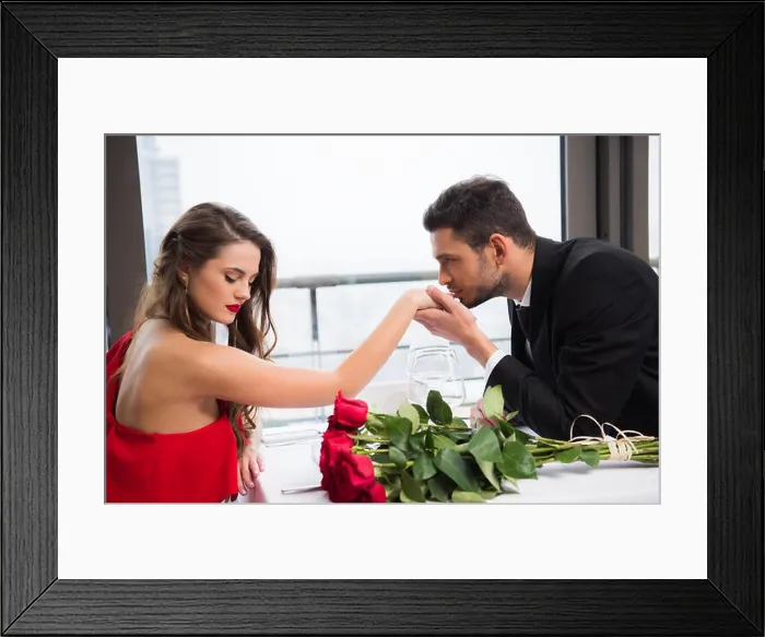 Framed Print : side view of man kissing girlfriends hand during date on st valentine day in restaurant Framed Print : side view of man kissing girlfriends hand during date on st valentine day in restaurant