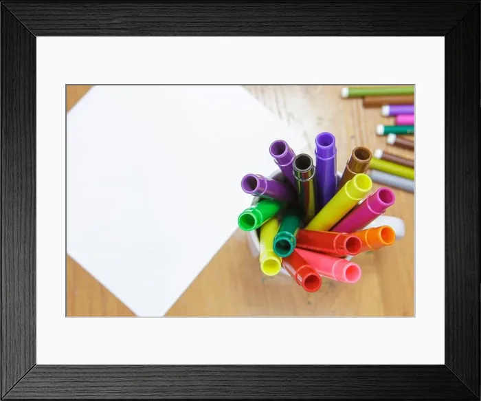 Framed Print : A set of colored markers and a sheet of white paper on the table Framed Print : A set of colored markers and a sheet of white paper on the table