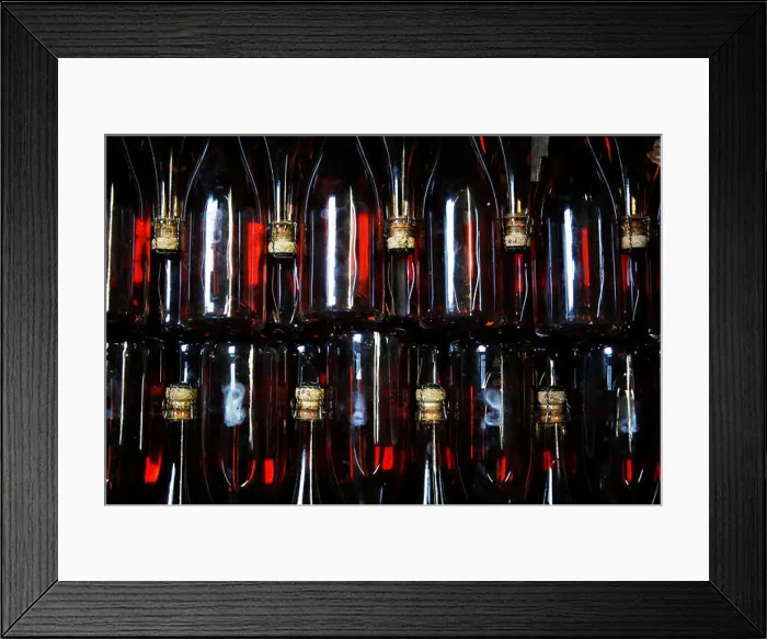 Framed Print : Bottles of sparkling Rose wait to be labeled at the winery of Hambledon Vineyard situated on the South Downs near Framed Print : Bottles of sparkling Rose wait to be labeled at the winery of Hambledon Vineyard situated on the South Downs near