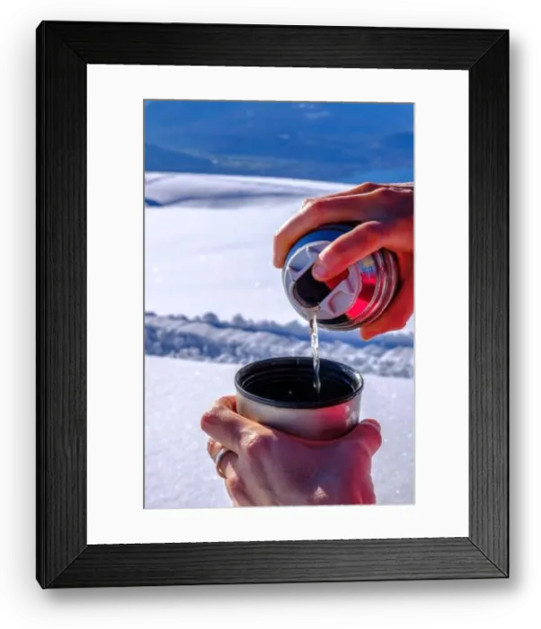 Framed Print : Spilling tea from a flask on the top of a mountain on a snow covered landscape Framed Print : Spilling tea from a flask on the top of a mountain on a snow covered landscape