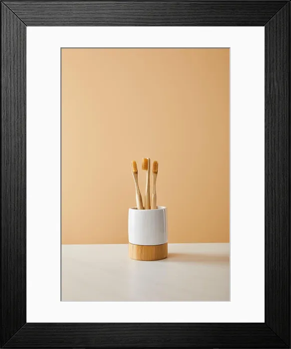 Framed Print : bamboo toothbrushes in holder on white table and beige background Framed Print : bamboo toothbrushes in holder on white table and beige background
