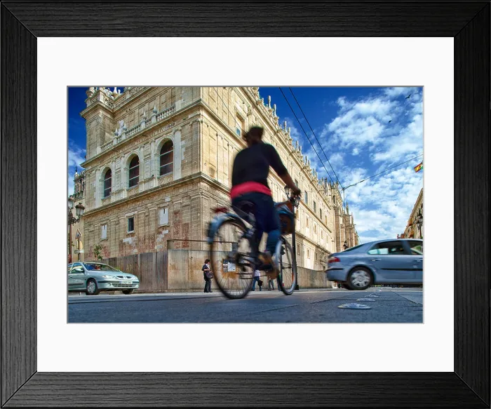 Framed Print : Cyclist in front of Sagrario Church, Constitution Avenue, Seville, Spain Framed Print : Cyclist in front of Sagrario Church, Constitution Avenue, Seville, Spain