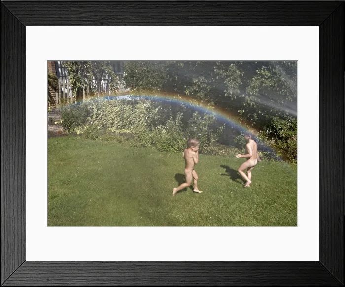 Framed Print : Two young boys or children playing with a hose in a suburban garden in summer with a rainbow in the spray London Framed Print : Two young boys or children playing with a hose in a suburban garden in summer with a rainbow in the spray London