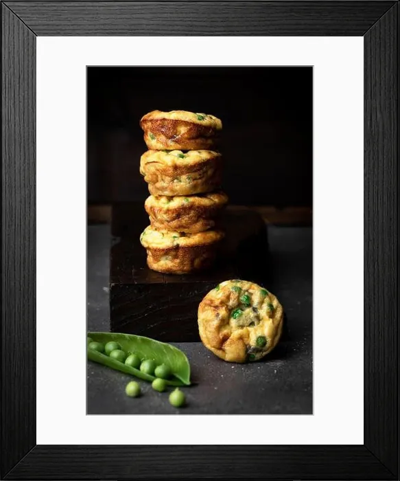 Framed Print : Side view still life of stacked pea muffins against dark background Framed Print : Side view still life of stacked pea muffins against dark background