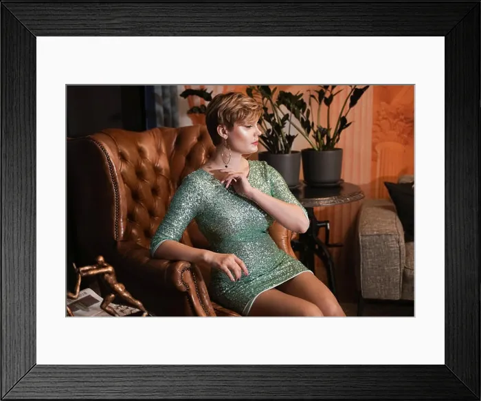 Framed Print : Attractive short hair blonde girl with curvy body in glitter evening tight dress is sitting in a vintage leather chair Framed Print : Attractive short hair blonde girl with curvy body in glitter evening tight dress is sitting in a vintage leather chair