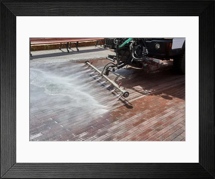 Framed Print : A special machine washes city paths and roads with water Framed Print : A special machine washes city paths and roads with water