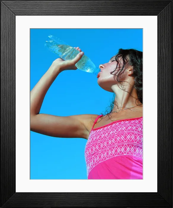 Framed Print : Thirst. Young woman drinking cold water in hot day