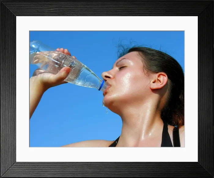 Framed Print : Young woman drinking cold water Framed Print : Young woman drinking cold water