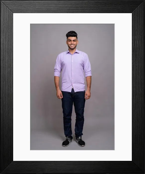 Framed Print : Young handsome Indian businessman against gray background Framed Print : Young handsome Indian businessman against gray background