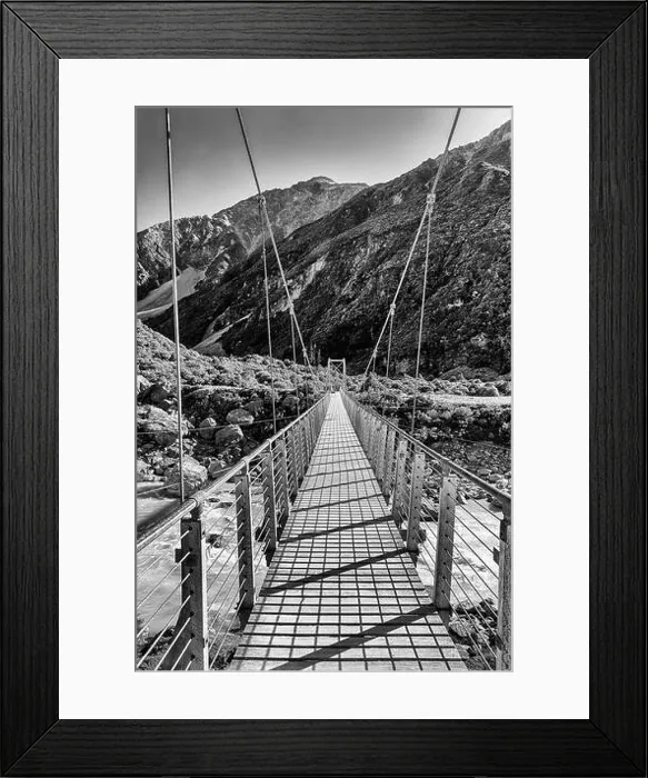Framed Print : Contrast BW hanging foot walking suspension bridge across Hooker river in scenic mountain valley of New Zealand on a Framed Print : Contrast BW hanging foot walking suspension bridge across Hooker river in scenic mountain valley of New Zealand on a