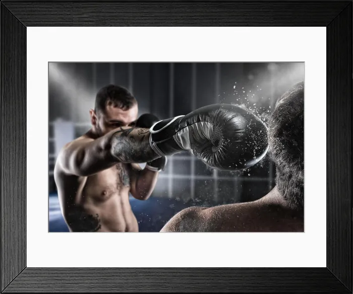 Framed Print : Boxer in a boxe competition beats his opponent Framed Print : Boxer in a boxe competition beats his opponent