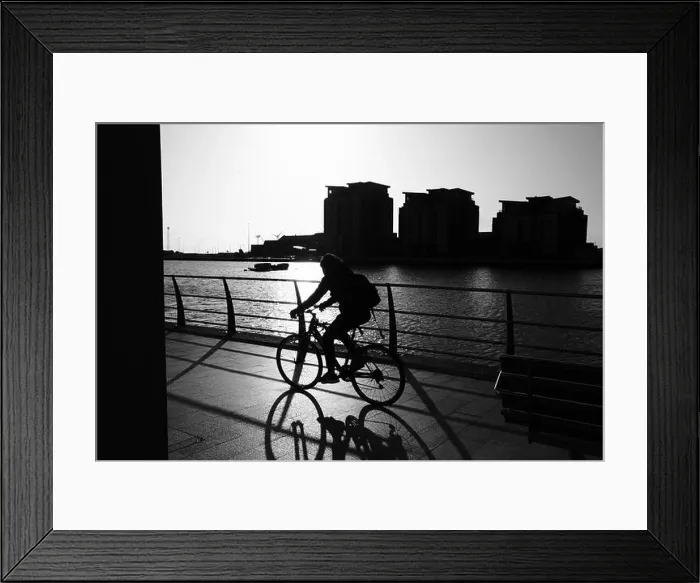 Framed Print : Cyclist commute on an early winter morning Swansea marina in silhouette Framed Print : Cyclist commute on an early winter morning Swansea marina in silhouette