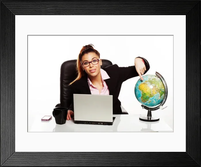 Framed Print : Businesswoman pointing to a world globe Framed Print : Businesswoman pointing to a world globe