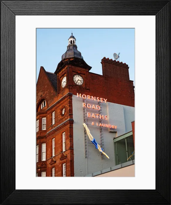 Framed Print : Looking up at a neon sign for the Hornsey Road Baths and Laundry
