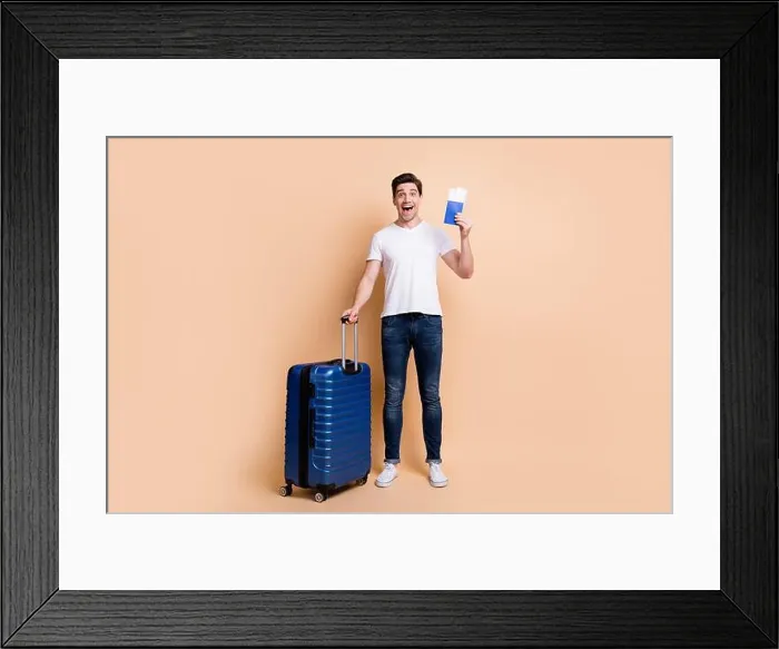 Framed Print : Full size photo of impressed brunet man stand hold tickets bag wear t-shirt jeans sneakers isolated on beige background
