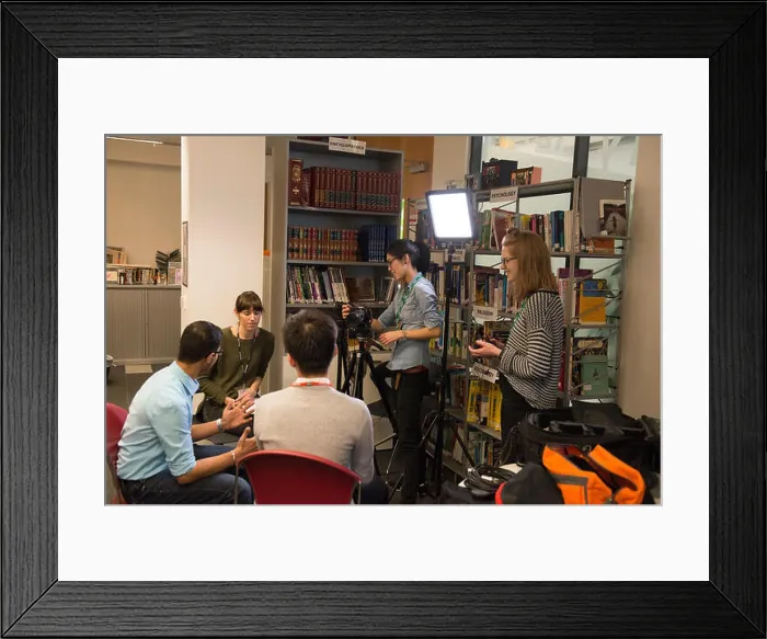 Framed Print : students on college campus take part in an organised social event in the library Framed Print : students on college campus take part in an organised social event in the library