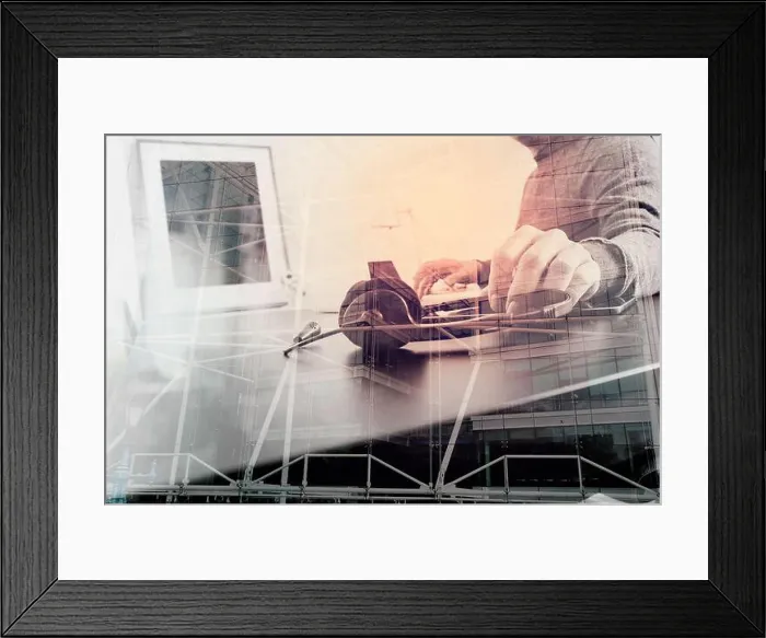 Framed Print : Man using VOIP headset with latop computer on desk in modern office as call center Framed Print : Man using VOIP headset with latop computer on desk in modern office as call center