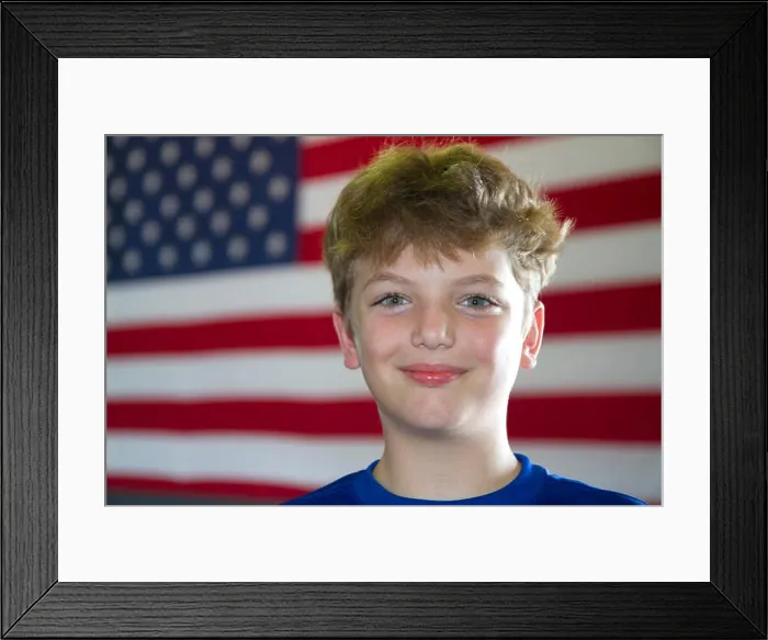 Framed Print : Ten year old american boy standing in front of an american flag in Charleston, South Carolina, USA. MR Framed Print : Ten year old american boy standing in front of an american flag in Charleston, South Carolina, USA. MR