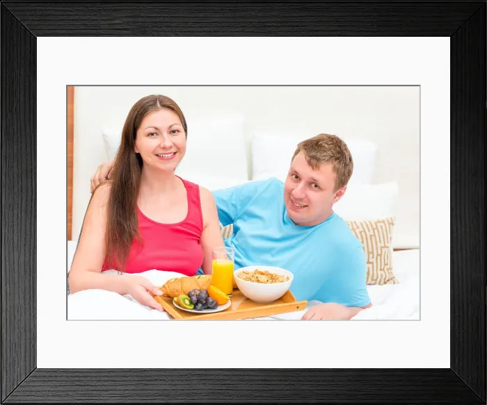 Framed Print : Portrait of a happy couple with breakfast on a tray Framed Print : Portrait of a happy couple with breakfast on a tray
