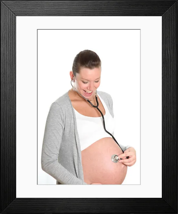Framed Print : Happy, pregnant woman with stethoscope on belly Framed Print : Happy, pregnant woman with stethoscope on belly