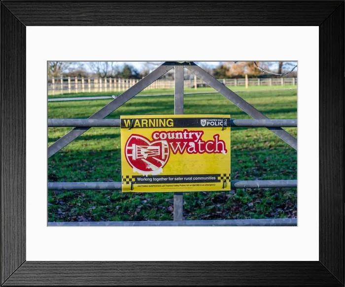 Framed Print : A sign attached to a metal gate on the entrance to a field warns people that a country watch is in force in this area Framed Print : A sign attached to a metal gate on the entrance to a field warns people that a country watch is in force in this area