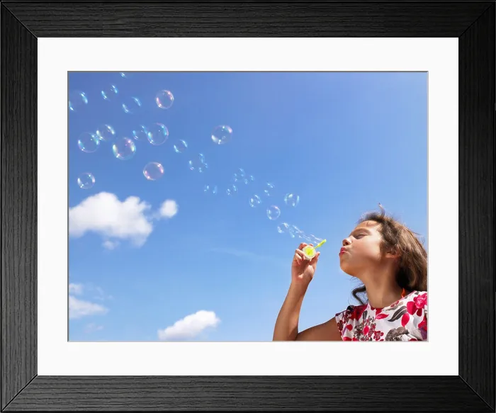 Framed Print : Little girl blowing bubbles Framed Print : Little girl blowing bubbles