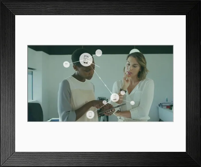 Framed Print : Image of connected icons over diverse female coworkers discussing reports on digital tablet Framed Print : Image of connected icons over diverse female coworkers discussing reports on digital tablet
