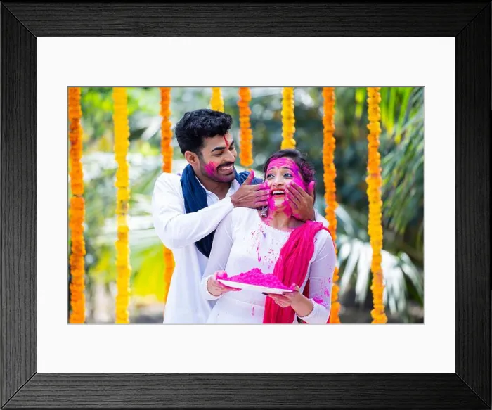 Framed Print : Happy indian young husband applying holi colors to wife face by holding holi powder plate during celebration holi Framed Print : Happy indian young husband applying holi colors to wife face by holding holi powder plate during celebration holi