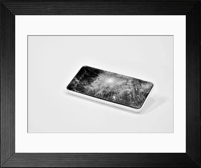 Framed Print : Cell phone with the screen broken by a hammer Framed Print : Cell phone with the screen broken by a hammer