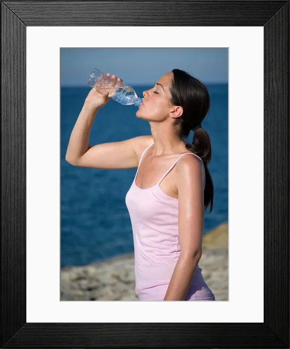 Framed Print : Woman drinking bottled water quenching thirst Framed Print : Woman drinking bottled water quenching thirst