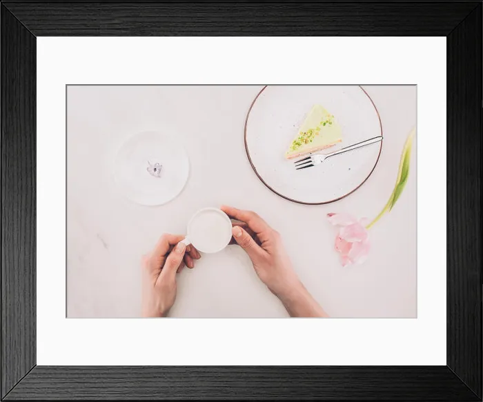 Framed Print : cropped shot of woman with cup of milk and piece of cake on plate on white surface Framed Print : cropped shot of woman with cup of milk and piece of cake on plate on white surface