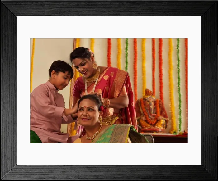 Framed Print : Boy helping his mom to tie his grandmother's hair during Ganesh Chaturthi Framed Print : Boy helping his mom to tie his grandmother's hair during Ganesh Chaturthi