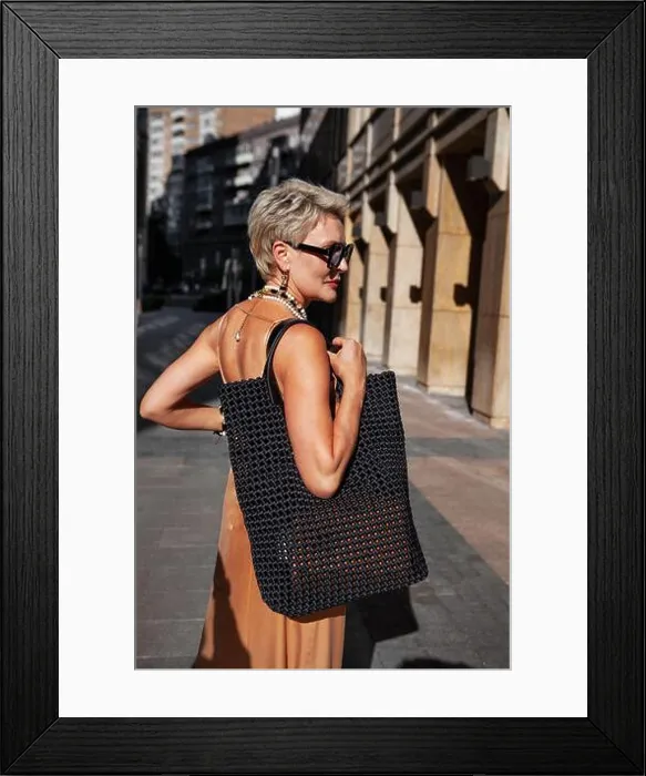 Framed Print : Fashionable Blonde Woman with Short Hair in stylish outfit with black woven bag Framed Print : Fashionable Blonde Woman with Short Hair in stylish outfit with black woven bag