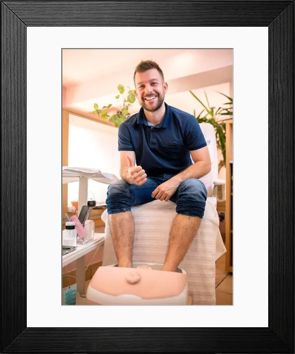 Framed Print : Young man in a pedicure salon sitting with his feet sunk in a spa bath Framed Print : Young man in a pedicure salon sitting with his feet sunk in a spa bath