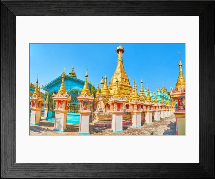 Framed Print : The carved golden pagoda amid the colorful temples and richly decorated shrines of Thanboddhay monastery Framed Print : The carved golden pagoda amid the colorful temples and richly decorated shrines of Thanboddhay monastery