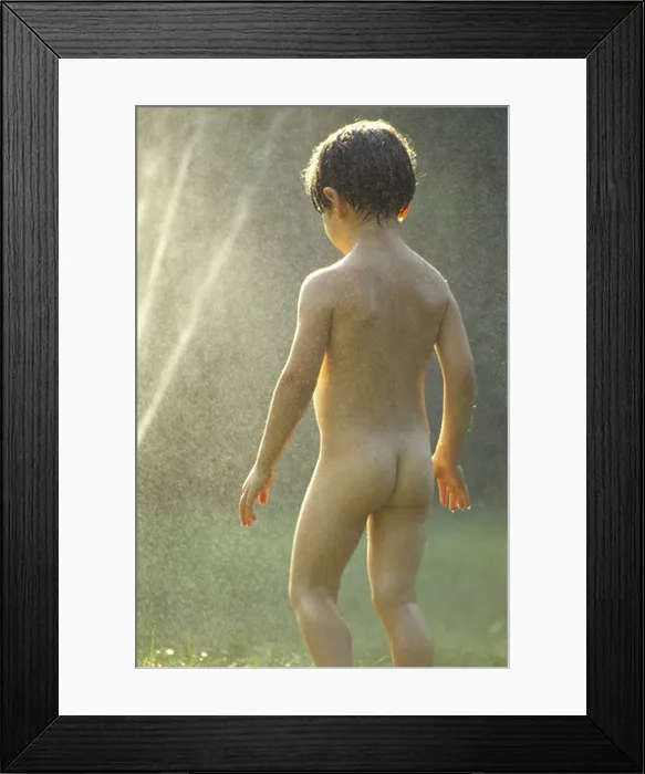 Framed Print : A child playing in water spray Framed Print : A child playing in water spray
