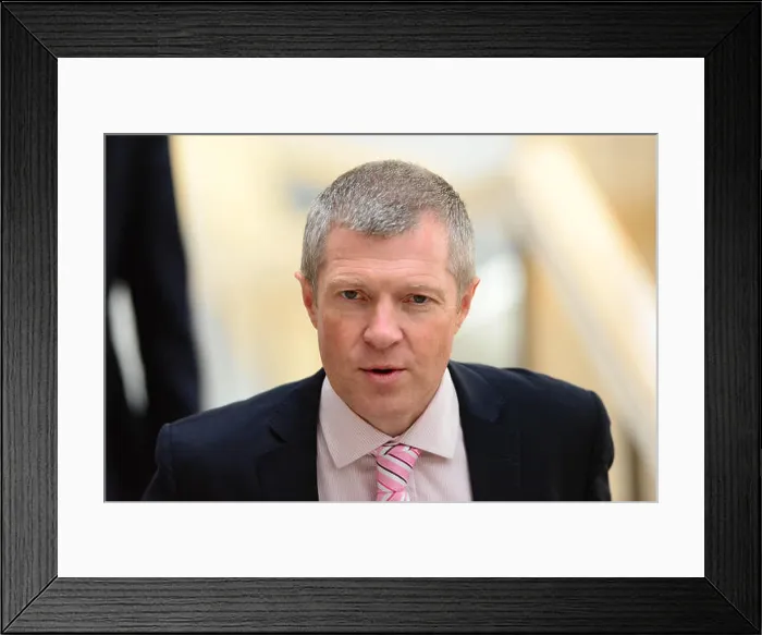 Framed Print : Scottish Liberal Democrat leader Willie Rennie makes his way to the chamber of the Scottish Parliament to listen to Framed Print : Scottish Liberal Democrat leader Willie Rennie makes his way to the chamber of the Scottish Parliament to listen to
