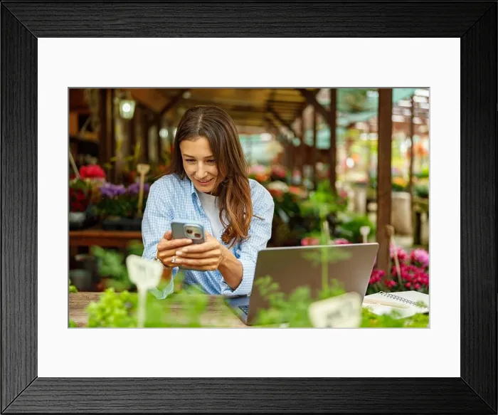 Framed Print : A woman is engaged in digital work while surrounded by the beauty of nature and greenery Framed Print : A woman is engaged in digital work while surrounded by the beauty of nature and greenery