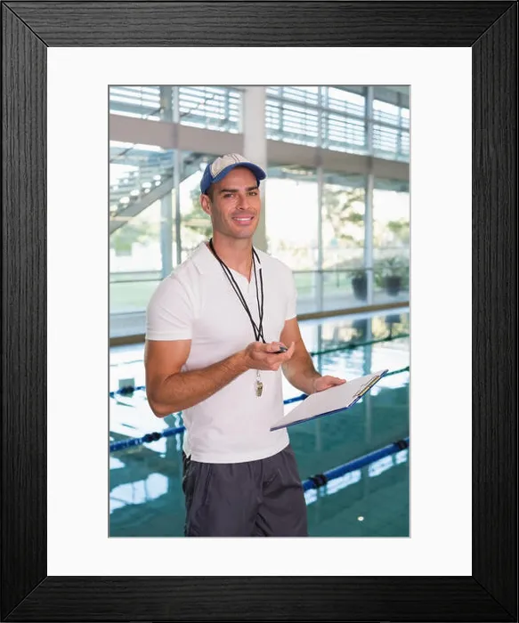 Framed Print : Swimming coach with stopwatch by pool at leisure center Framed Print : Swimming coach with stopwatch by pool at leisure center