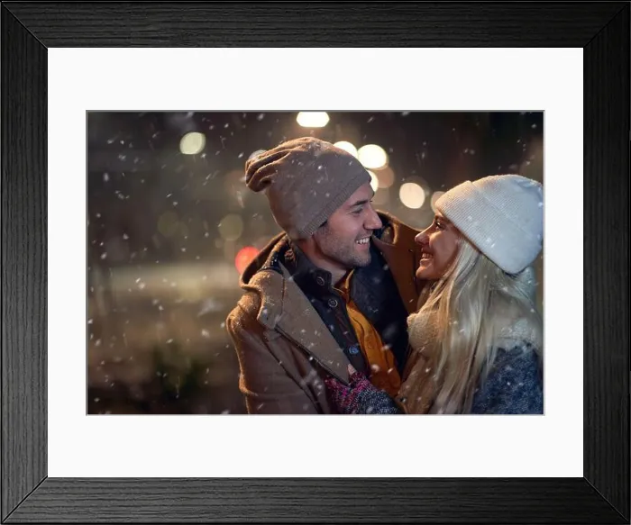 Framed Print : A young couple in romantic moments on a magical night on a snowy weather in the city. Love, together, walk, snow, city Framed Print : A young couple in romantic moments on a magical night on a snowy weather in the city. Love, together, walk, snow, city