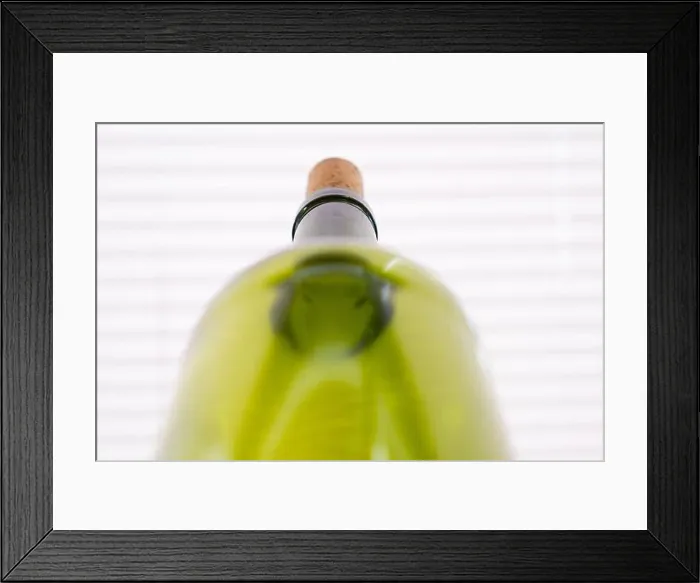Framed Print : composition with green bottles of red wine on neutral light background Framed Print : composition with green bottles of red wine on neutral light background